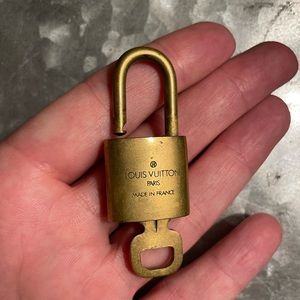 Louis Vuitton lock . Locks and open with key.